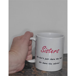 humorous coffee mug sister's we don't just share the load, we share the calories! held in hand